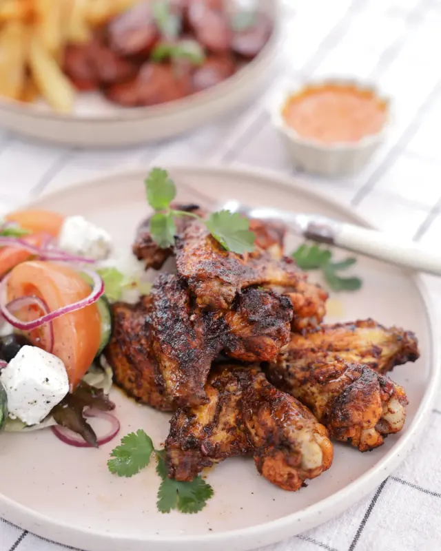Chicken wings with salad and chouriço in the background - Parreirinha Rapido Illovo